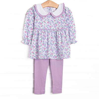 This set features a lavender floral print, a peter pan collar with ruffle trim, and purple leggings to match. 