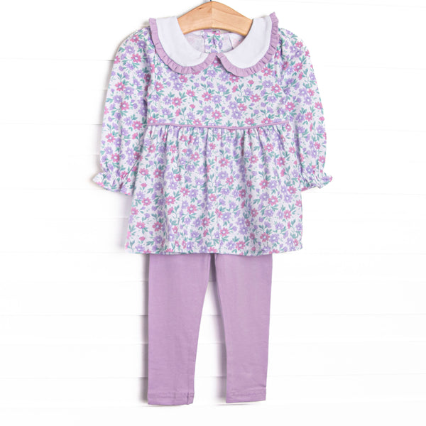 This set features a lavender floral print, a peter pan collar with ruffle trim, and purple leggings to match. 