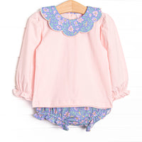 This set features a pink top, floral Peter Pan collar, and purple floral diaper cover to match.