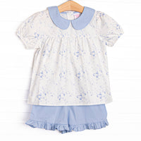This set features a blue floral print, puff sleeves, and a peter pan collar, Coordinating blue ruffle shorts to match.