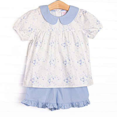 This set features a blue floral print, puff sleeves, and a peter pan collar, Coordinating blue ruffle shorts to match.
