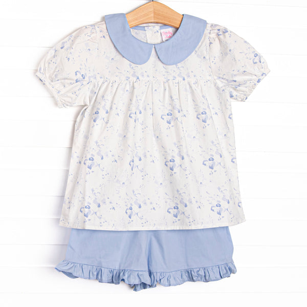 This set features a blue floral print, puff sleeves, and a peter pan collar, Coordinating blue ruffle shorts to match.