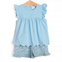 This set features a blue scalloped trimmed top and blue floral ruffle shorts to match