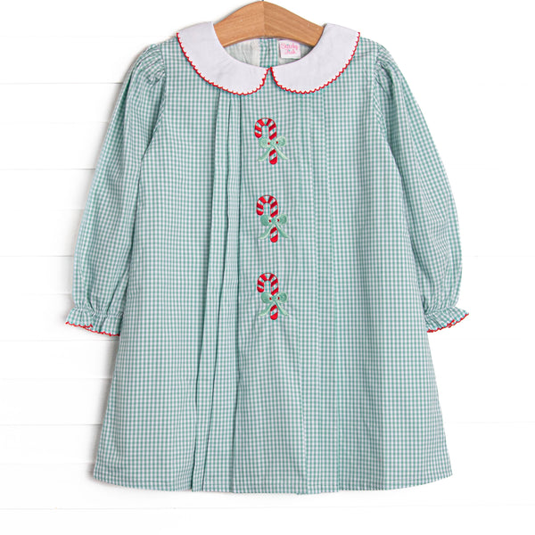 This dress features a sage green gingham, a peter pan collar, and candy cane embroideries.