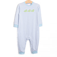  This romper features a blue striped fabric, dinosaur appliques, and snaps along the stride to make changing a breeze. 