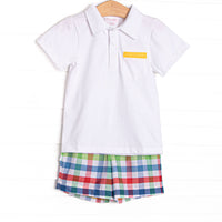 This set features a polo top with yellow trim and primary color check shorts to match.