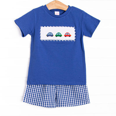 This set&nbsp; features a royal blue short sleeve top with trio of cars smockings and blue gingham shorts to match.