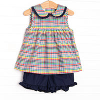 This set features a plaid print, a navy blue ruffle collar, and coordinating navy blue ruffle shorts to match