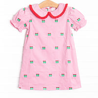 This dress features pink corduroy material, gift box embroideries, and a peter pan collar with red ruffle trim.