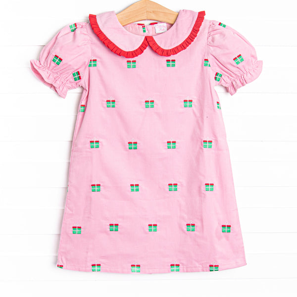 This dress features pink corduroy material, gift box embroideries, and a peter pan collar with red ruffle trim.