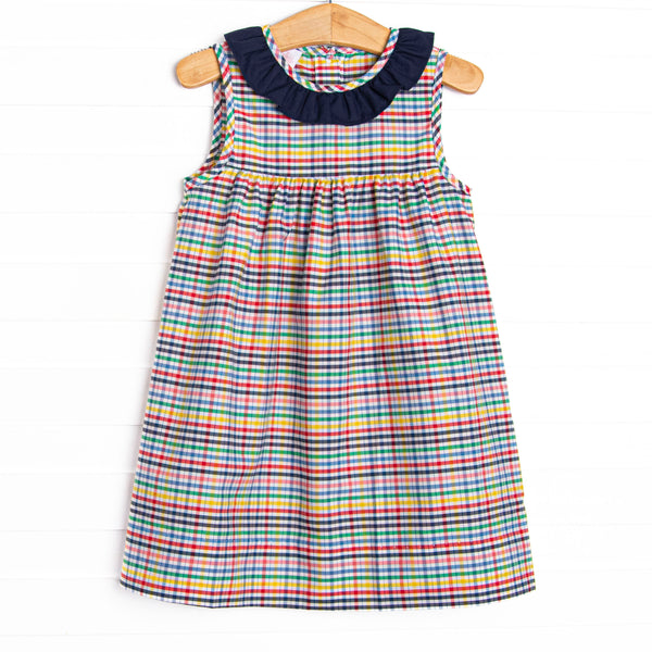 This dress features a plaid print, button closure on the back, and a navy blue ruffle collar