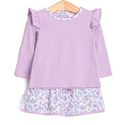 This set features a purple top, flutter shoulders, and a floral skirt to match.