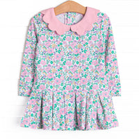 This dress features a pink floral print, a pink scalloped collar, and the best performance fabric.