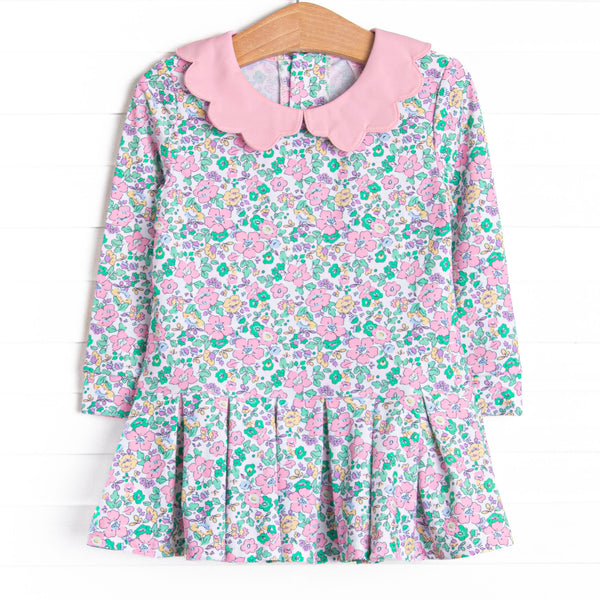 This dress features a pink floral print, a pink scalloped collar, and the best performance fabric.