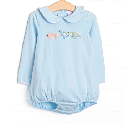  This bubble features blue knit fabric, dinosaur appliques, and a blue Peter Pan collar. 