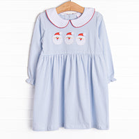This dress features soft blue stripes, peter pan collar, and a Santa trio applique.