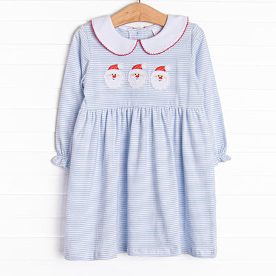 This dress features soft blue stripes, peter pan collar, and a Santa trio applique.