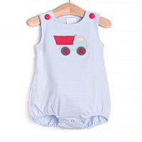 This bubble features a blue striped print, red buttons, and a dump truck applqiue