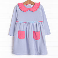 This dress features periwinkle stripes, front pockets, and a peter pan collar with ruffle trim.