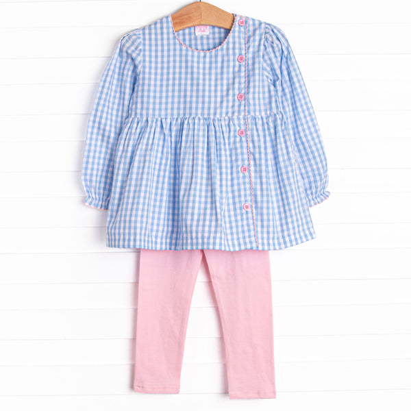 This set features a blue gingham top with a ruffle collar, pink buttons, and pink leggings to match.