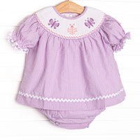  This set features a purple seersucker print, white ric rac trim, and butterfly smockings. 