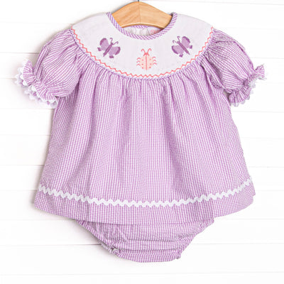  This set features a purple seersucker print, white ric rac trim, and butterfly smockings. 