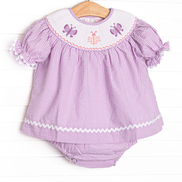  This set features a purple seersucker print, white ric rac trim, and butterfly smockings. 