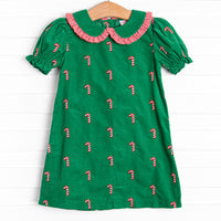 This dress features a green corduroy, puff sleeves, and candy cane embroideries
