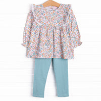 This set features a blue floral print, eyelet lace trim, and blue leggings to match.
