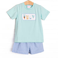 This set features a mint green short sleeve top with a magical treat smocking and blue gingham print shorts.