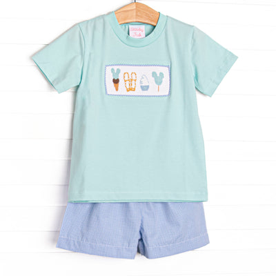 This set features a mint green short sleeve top with a magical treat smocking and blue gingham print shorts.