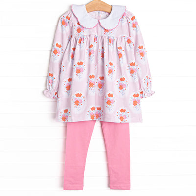 This set features a pink floral print, a scalloped collar, and pink leggings to match.