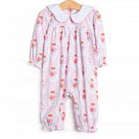 This romper features a pink floral print, a scalloped collar, and snaps on the stride.