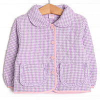 This coat features a purple gingham quilted material, a peter pan collar, and pink buttons.