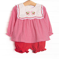 This set features red gingham fabric, a white bib collar, and strawberry and bow embroidery. Coordinating red bloomer shorts to match.
