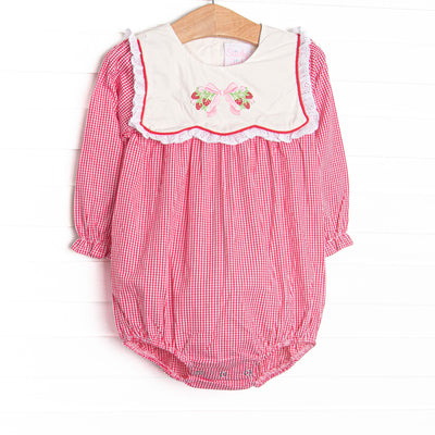 This bubble features red gingham fabric, a white bib collar, and strawberry and bow embroidery.
