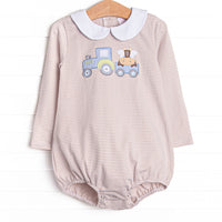  This bubble features a tan striped print, snaps on the stride, and a tractor and cow applique. 