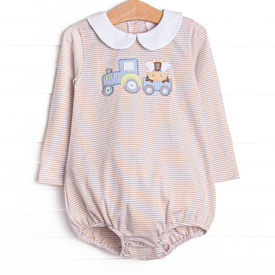  This bubble features a tan striped print, snaps on the stride, and a tractor and cow applique. 
