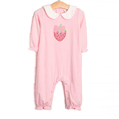 his romper features pink knit fabric, a white Peter Pan collar, strawberry and bow appliques, and snaps along the stride to make changing a breeze