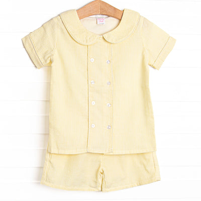 This set features a yellow seersucker print, a peter pan collar, and front covered buttons. Coordinating yellow seersucker shorts to match.