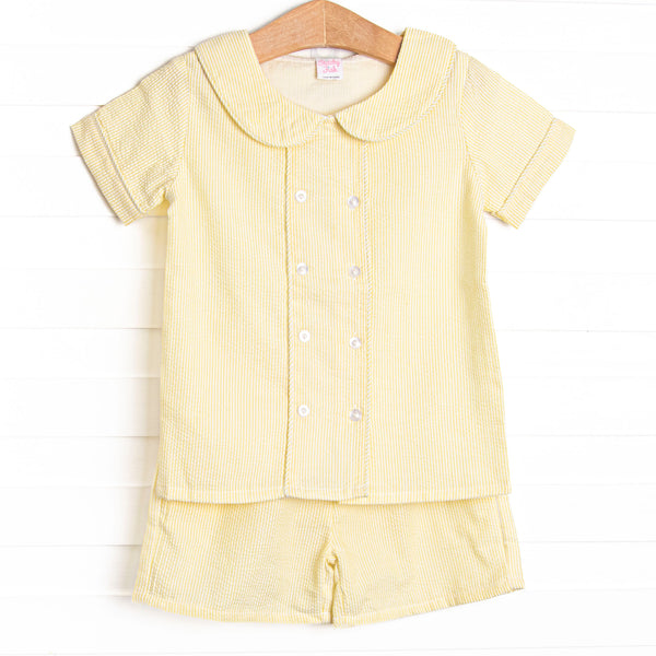 This set features a yellow seersucker print, a peter pan collar, and front covered buttons. Coordinating yellow seersucker shorts to match.