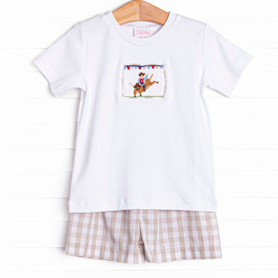 This set features a shorts sleeve top with a cowboy smocking and tan check shorts to match.