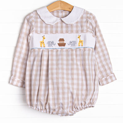  This long sleeve romper is featured in a tan gingham print with a white peter pan collar and a Noah's Ark smocking. 