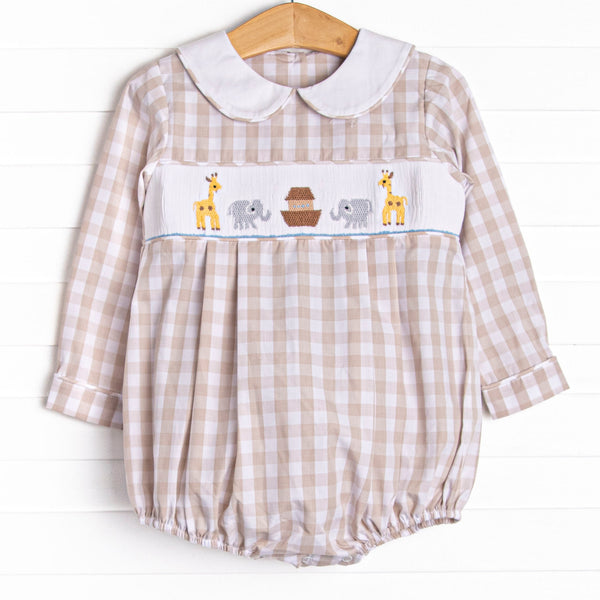  This long sleeve romper is featured in a tan gingham print with a white peter pan collar and a Noah's Ark smocking. 