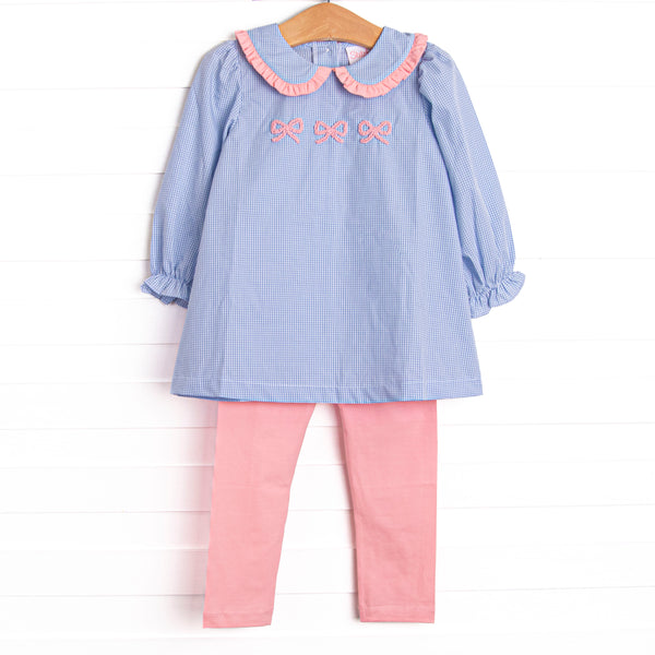 This set features a blue gingham print, a peter pan collar with pink ruffle trim, and a trio of bow embroideries. Coordinating pink leggings to match.