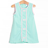 This dress features a mint green knit material, pink trim, and pink bows embroidery
