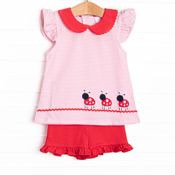 This set features a pink striped print, a red peter pan collar, and a lady bug applique. Coordinating red ruffle shorts to match.
