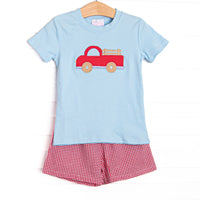 This set features a blue short sleeve top with a red truck applique and red gingham shorts to match.
