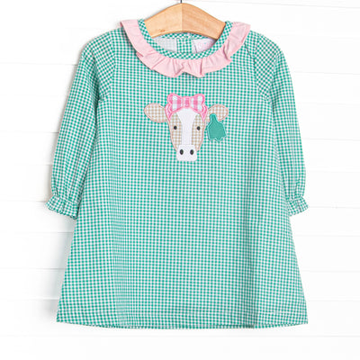 This dress features mint green gingham, a pink ruffle collar, and a cow applique