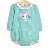This bubble features mint green gingham, a pink ruffle collar, and a cow applique.